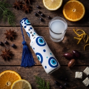 Greek Ouzo 50ml White Mini Bottle with Aegean Blue Evil Eye Charm on a clean ecommerce background